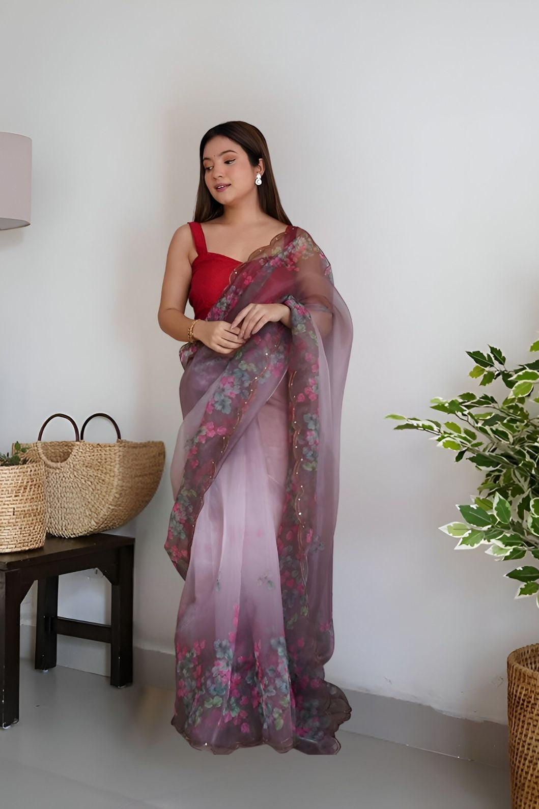 Front angle of wine colored organza saree with floral prints