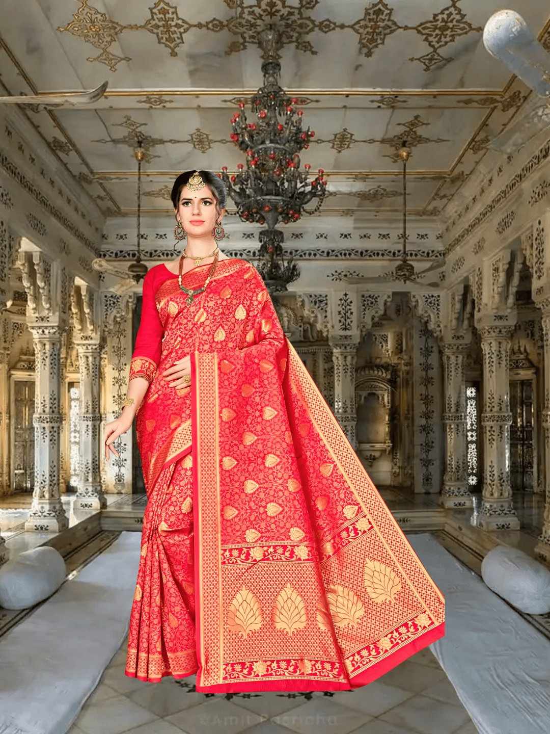 Close-up of golden zari border work on deep red Banarasi silk