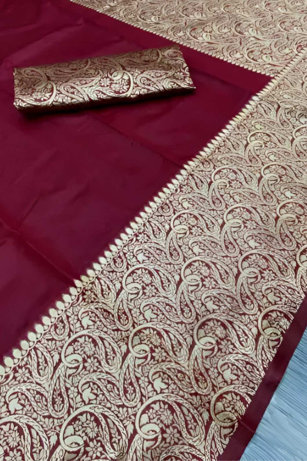 Closeup of fabric showing fine Lichi weave and deep maroon shade – lifestyle background