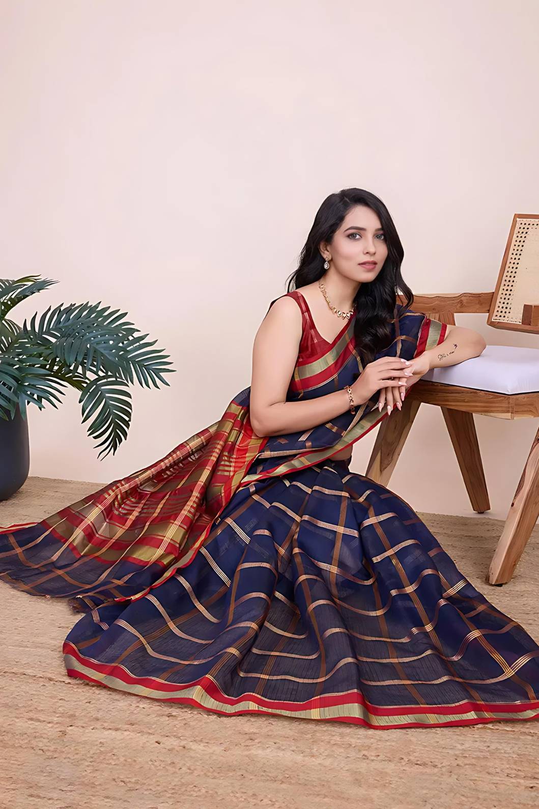 Front view of navy blue checkered saree radiating elegance in palace lighting