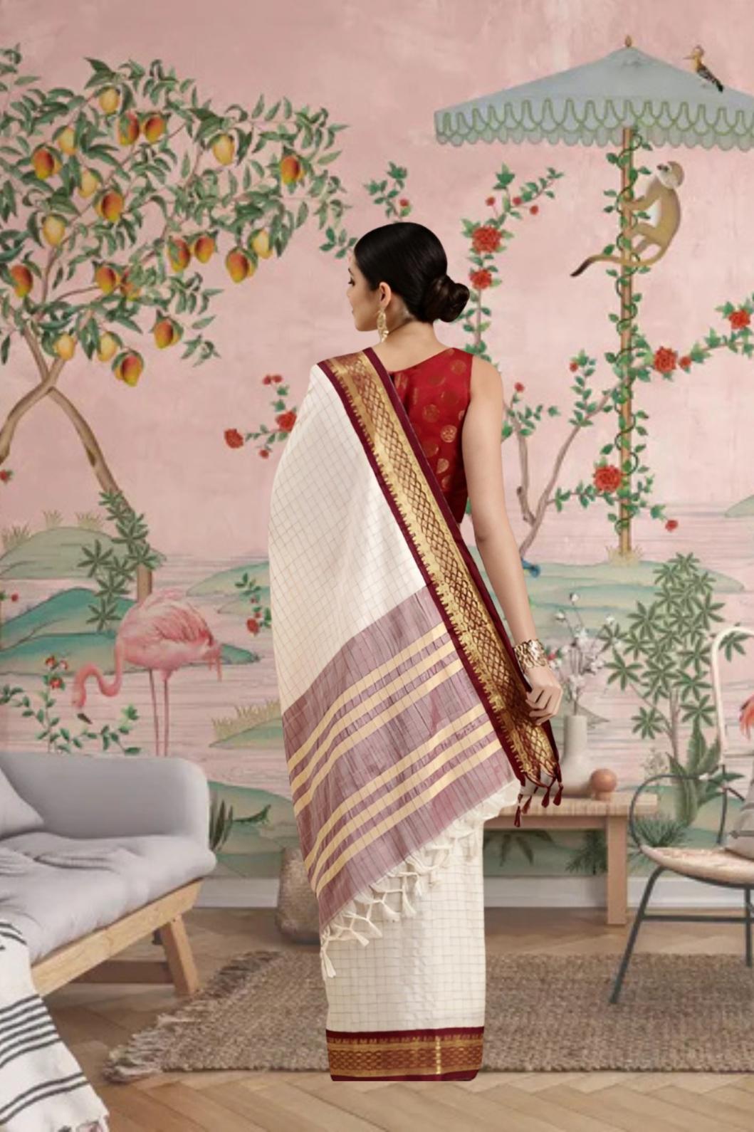 Rear profile showing deep maroon pallu in palace ambience