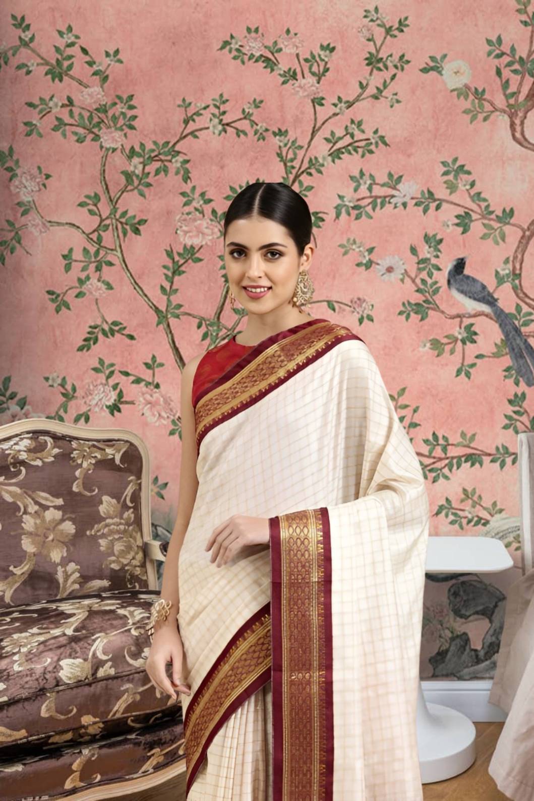 Front view of white checkered cotton silk saree with maroon border in regal setting