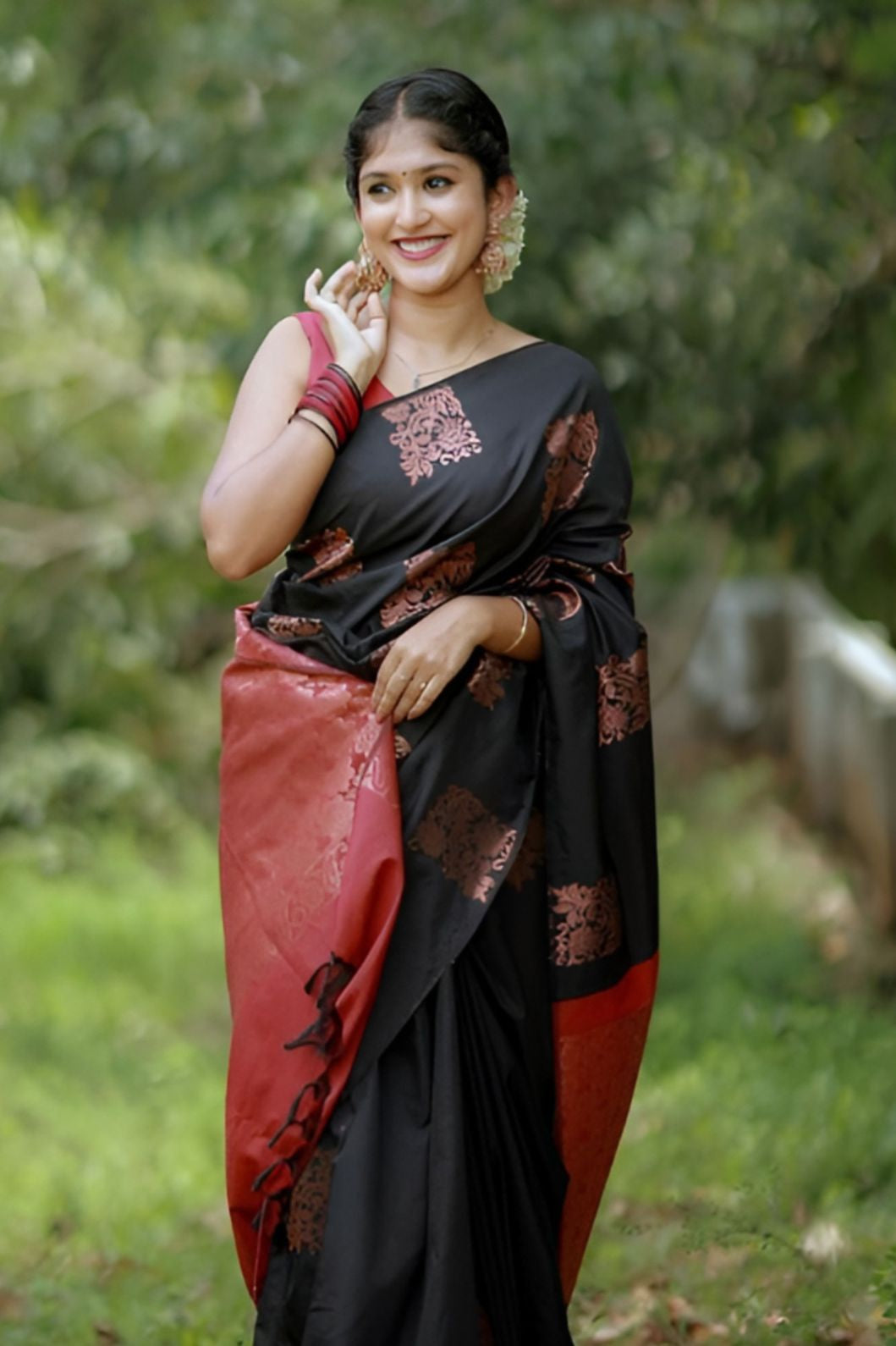 Front view of black-red silk saree in outdoor setting