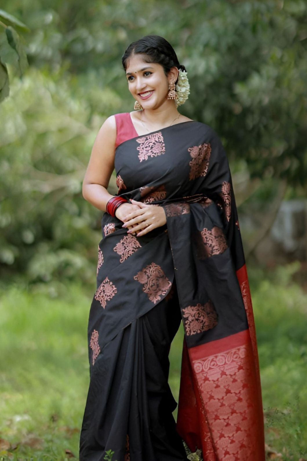 Front view of black-red silk saree in outdoor setting