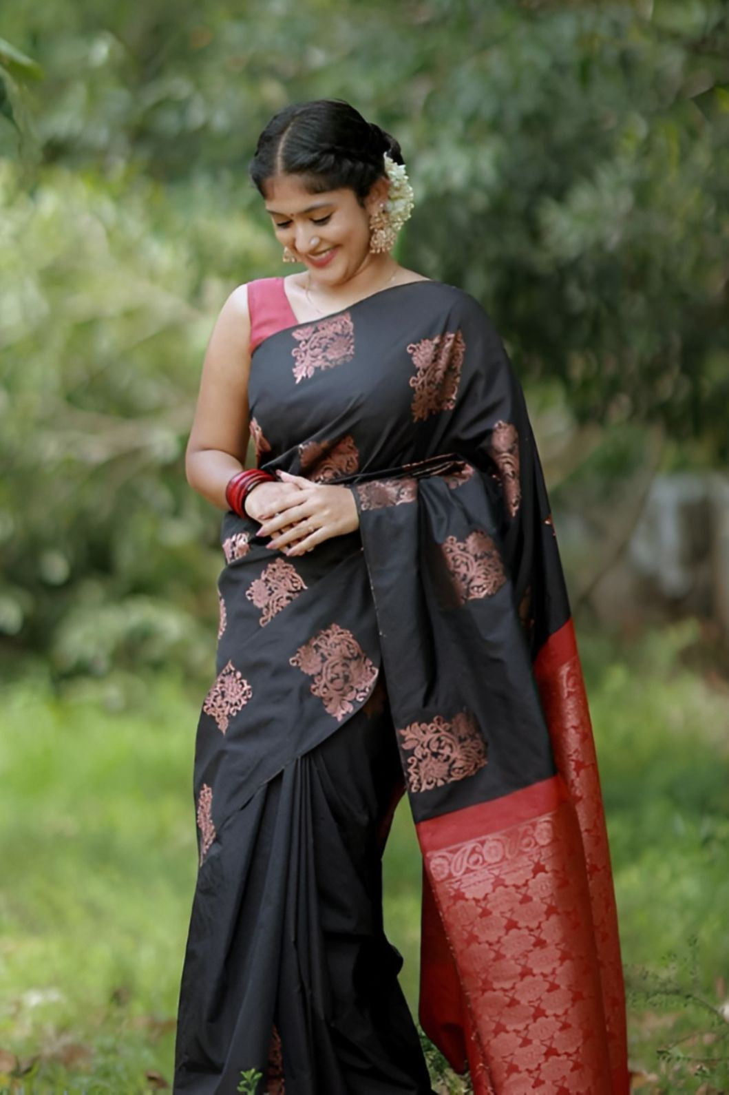 Front view of black-red silk saree in outdoor setting