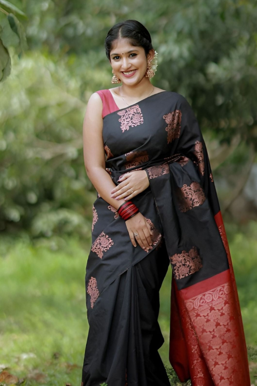 Front view of black-red silk saree in outdoor setting