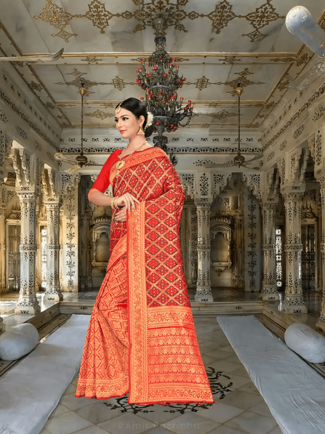 Model in red Banarasi silk saree with gold motifs in palace setting