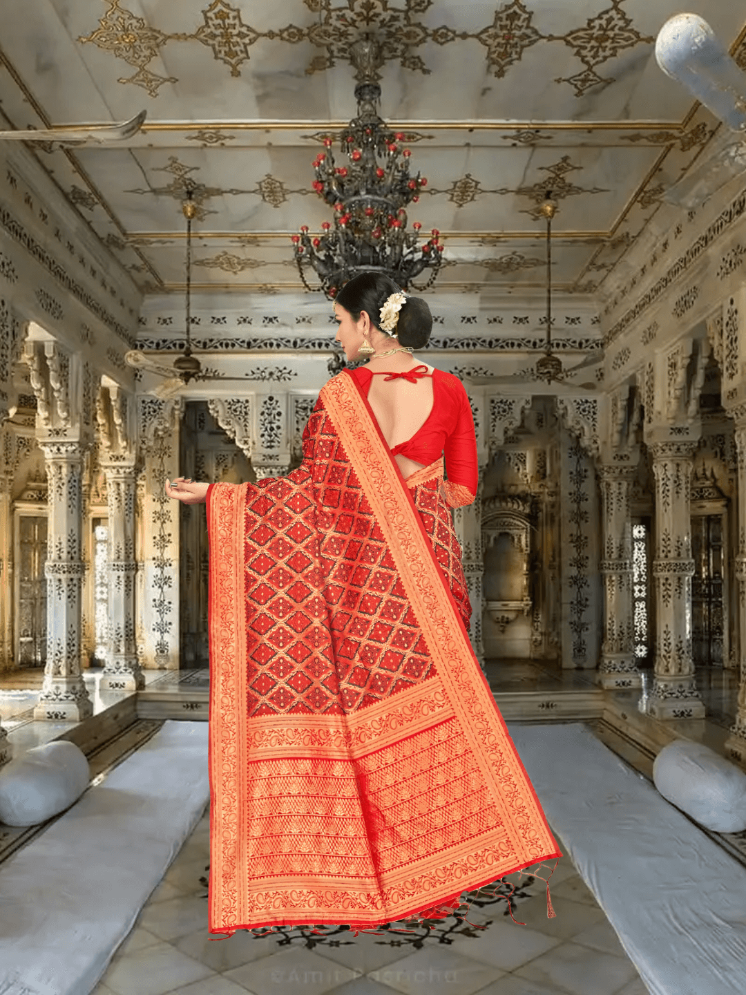 Golden pallu of red silk saree flowing in royal palace backdrop
