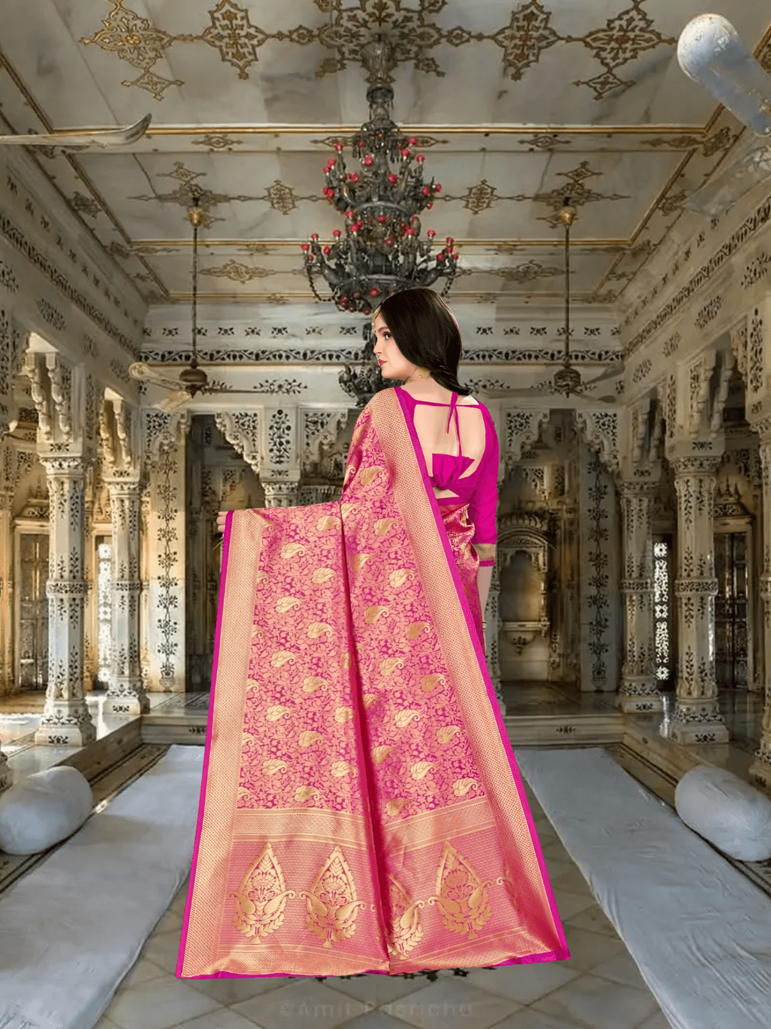 Golden pallu of pink silk saree elegantly flowing in regal backdrop