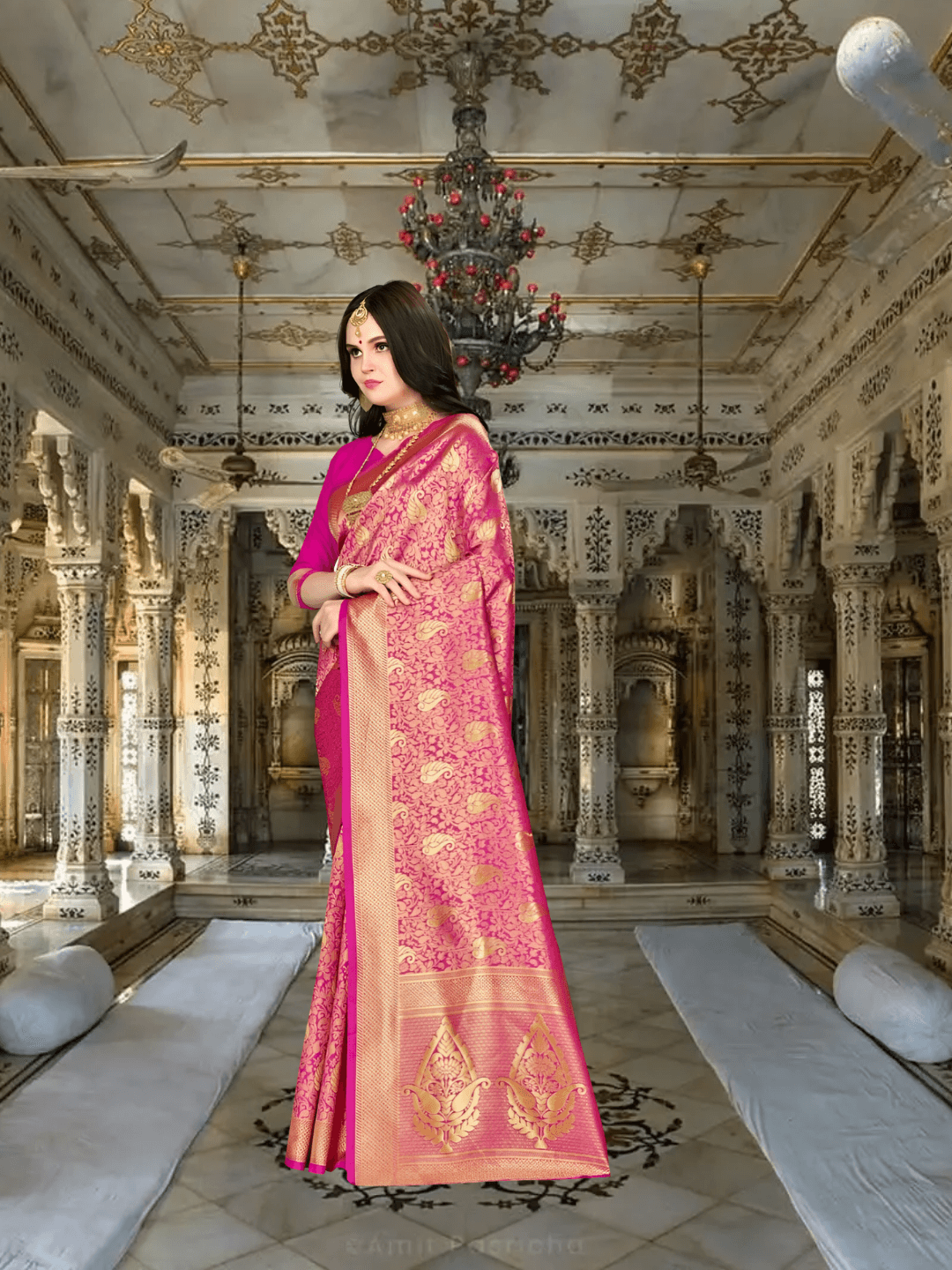 Close-up of unique golden motifs on pink Banarasi silk with palace lights