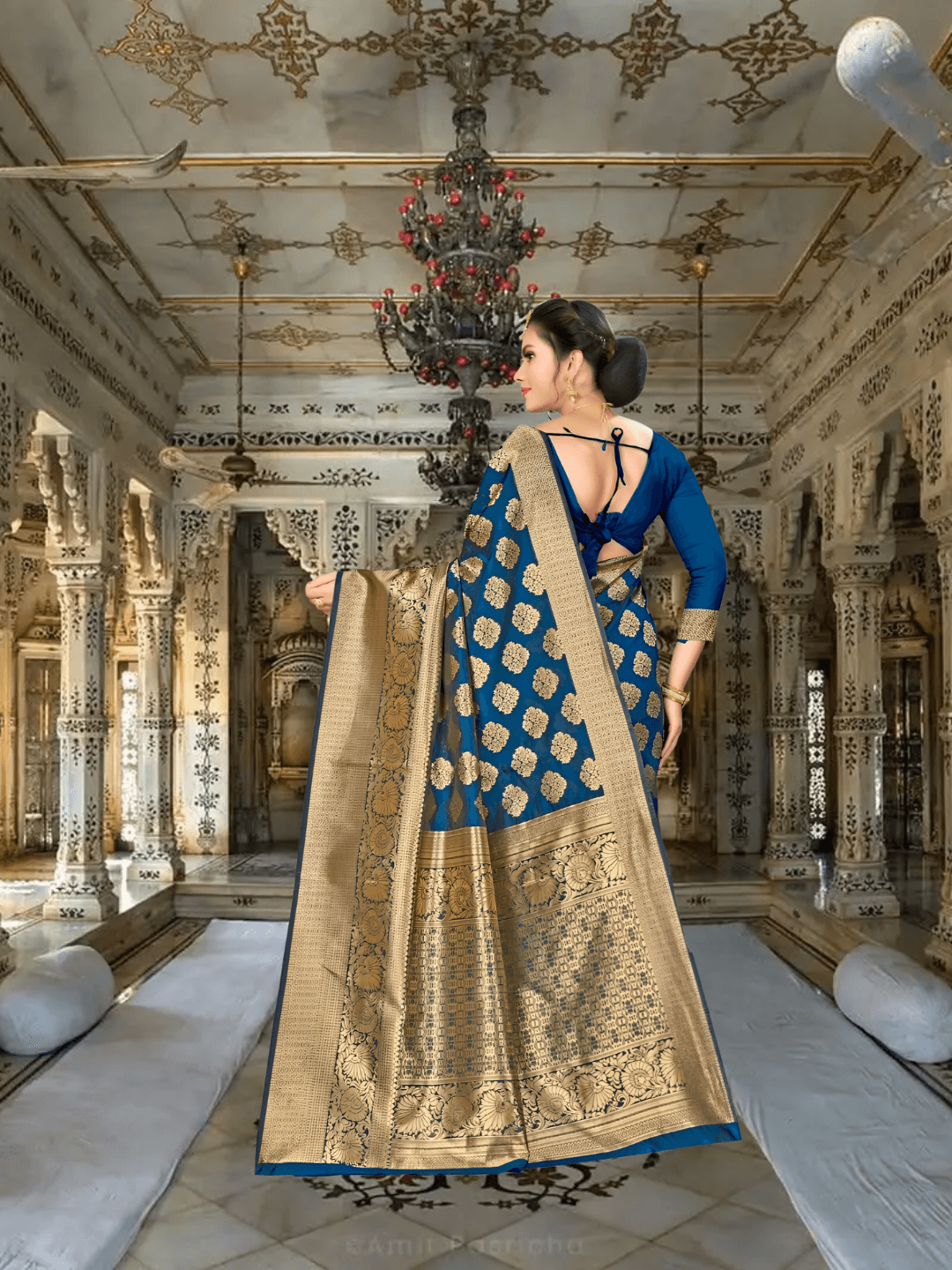 Close-up of golden zari pallu on teal Banarasi saree in a royal ambience