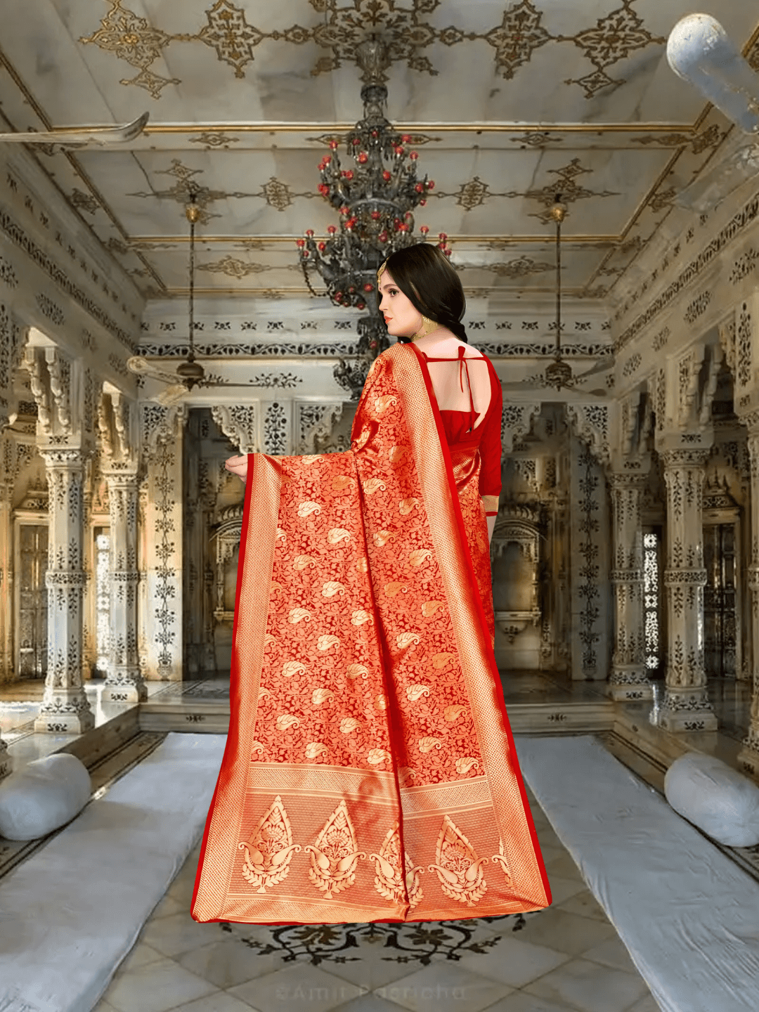 Pallu draping richly with gold zari on red Banarasi silk in heritage backdrop