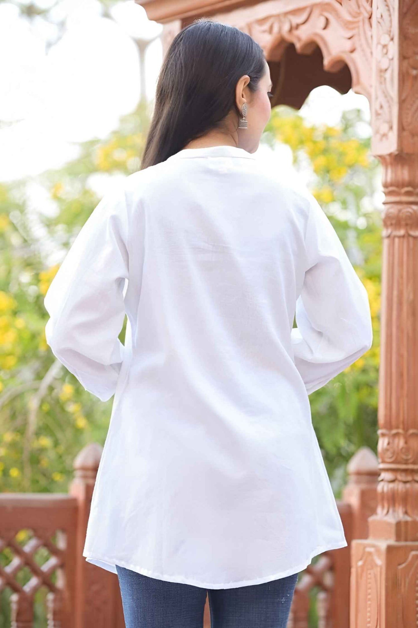 Back detail of band collar tunic, seams precise as a monk’s parchment folds, glowing in muted daylight