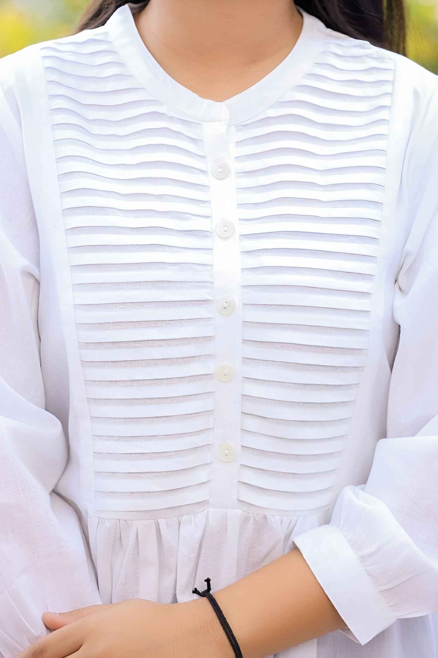 Garment arranged on aged paper, cotton mimicking cracked ivory relics