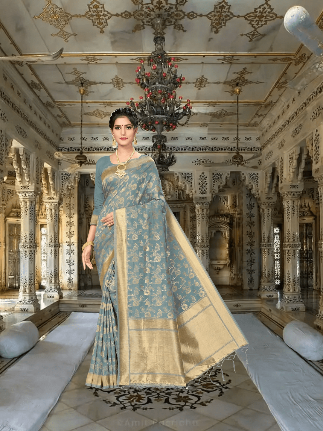 Close-up of golden patterns on grey cotton saree inside palace room