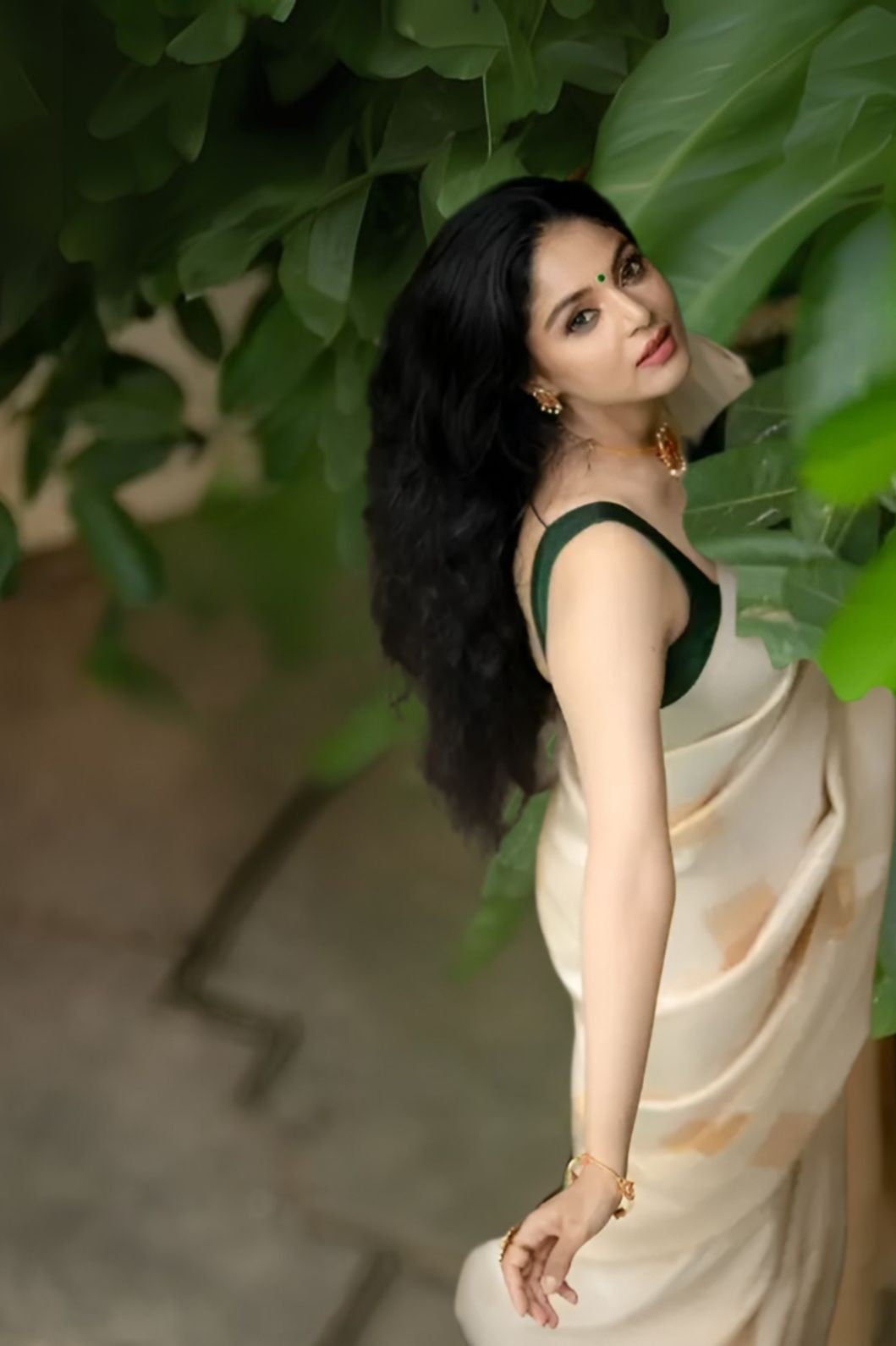 Front view of off-white silk saree in regal room setting