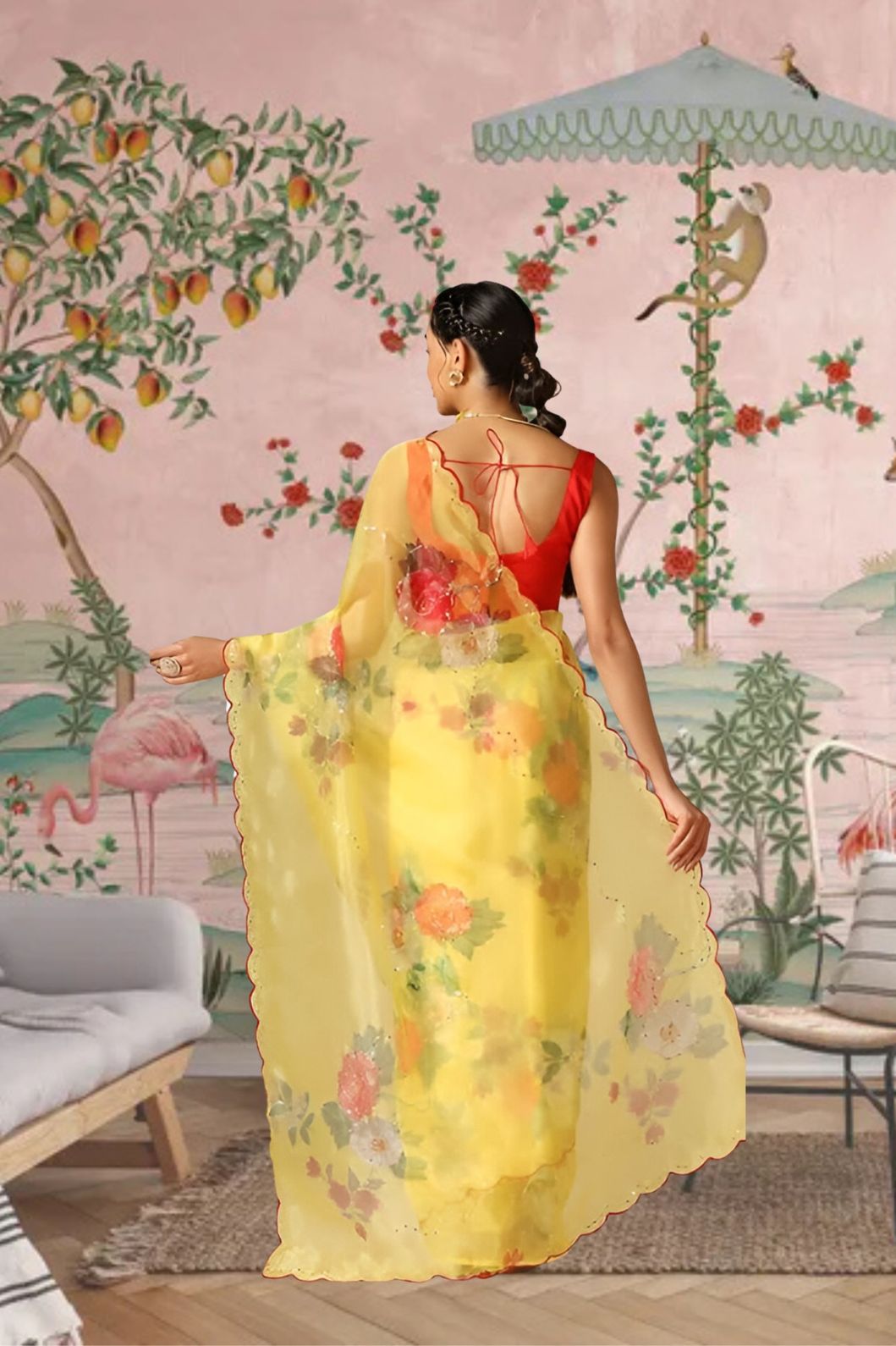 Back view showing the airy drape of the yellow printed saree