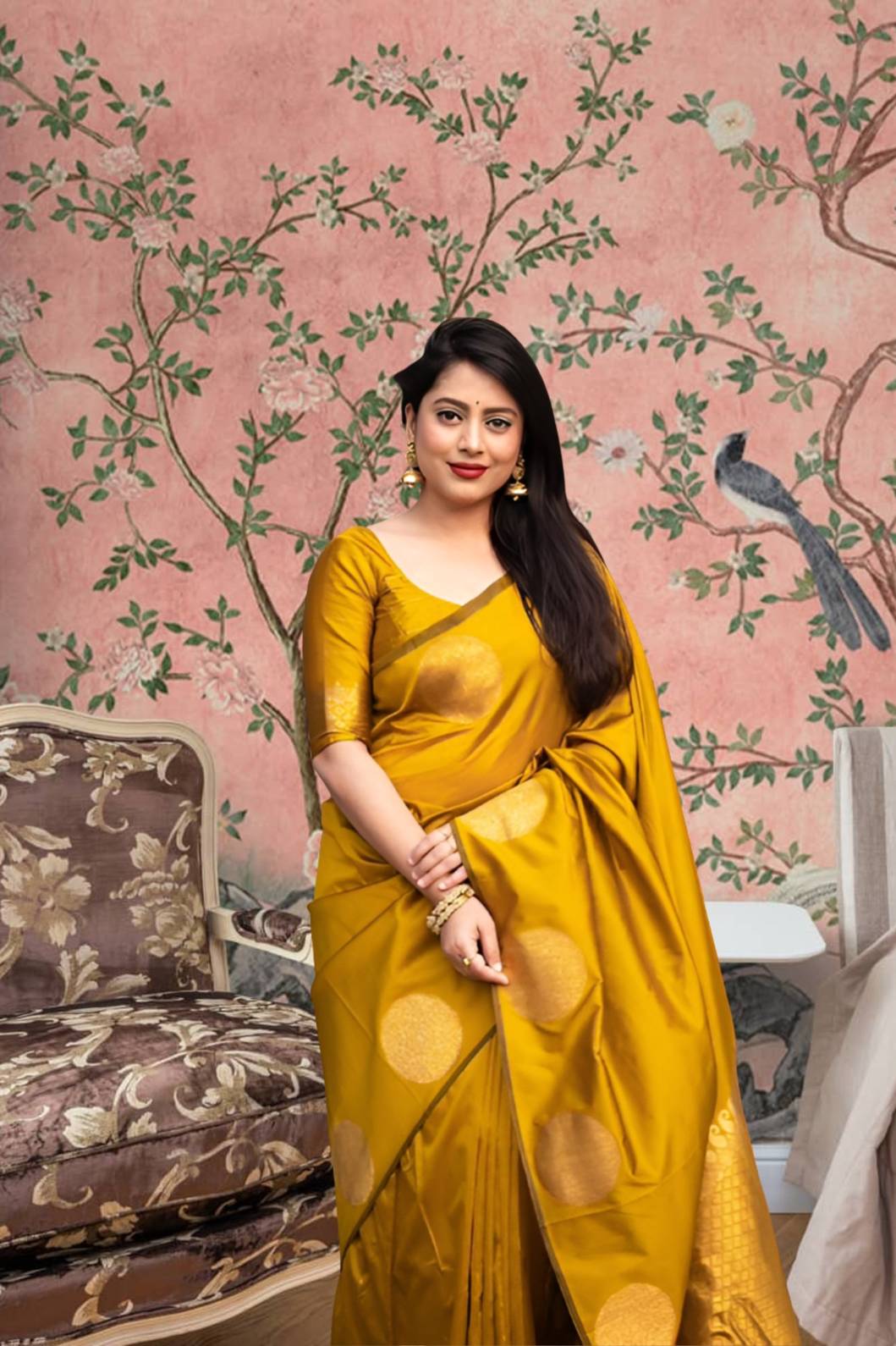 Front view of yellow silk printed saree glowing in regal setting