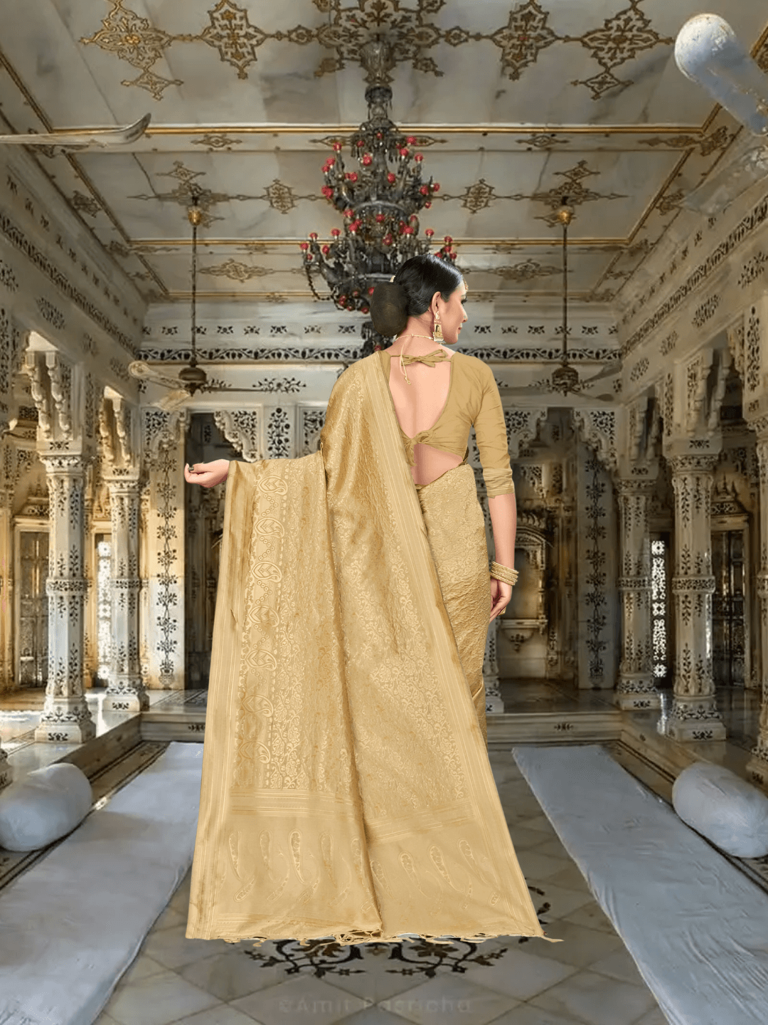 Flowing pallu of golden silk saree with regal interior in background