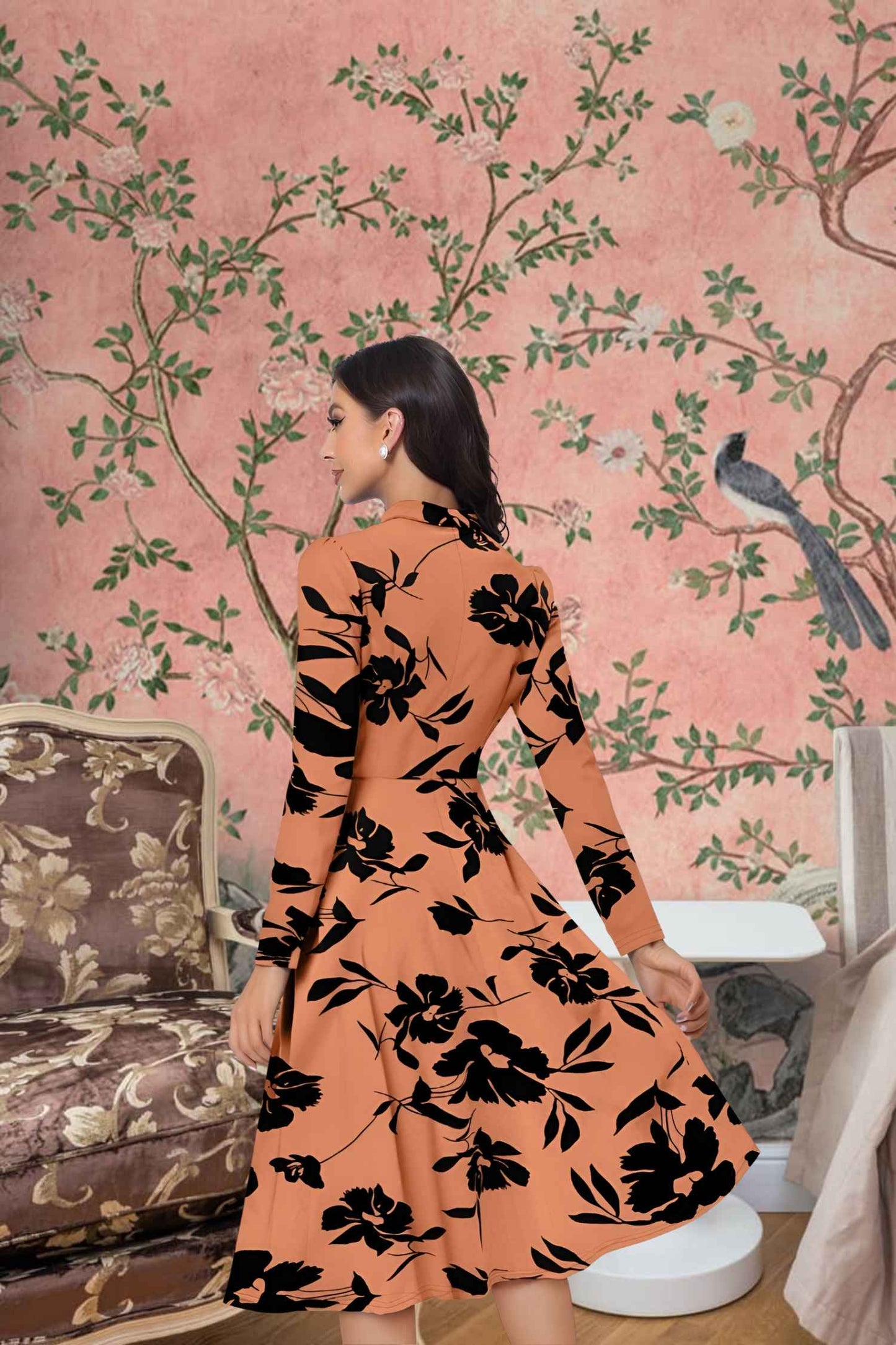 Back view of orange Thaaravesha dress showing elegant fit and length