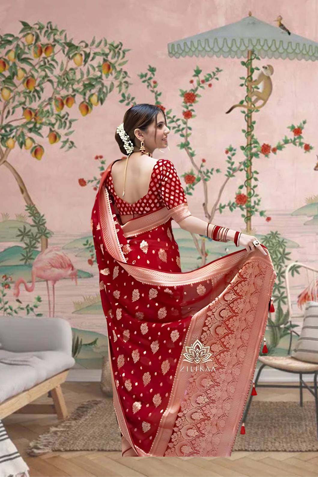 Back profile showcasing bold red pallu in ceremonial lighting