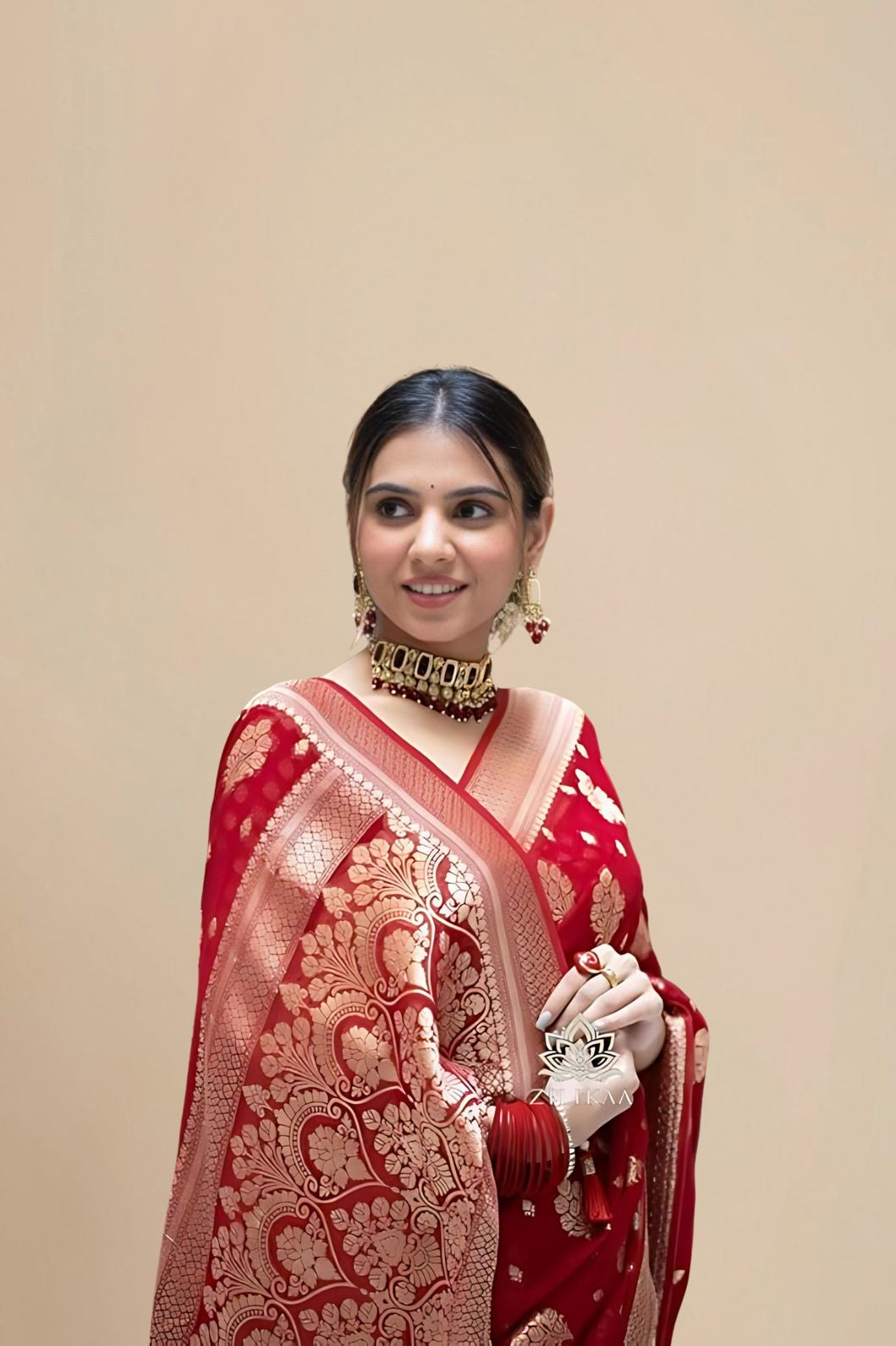 Studio close-up of red pallu and cotton texture blend