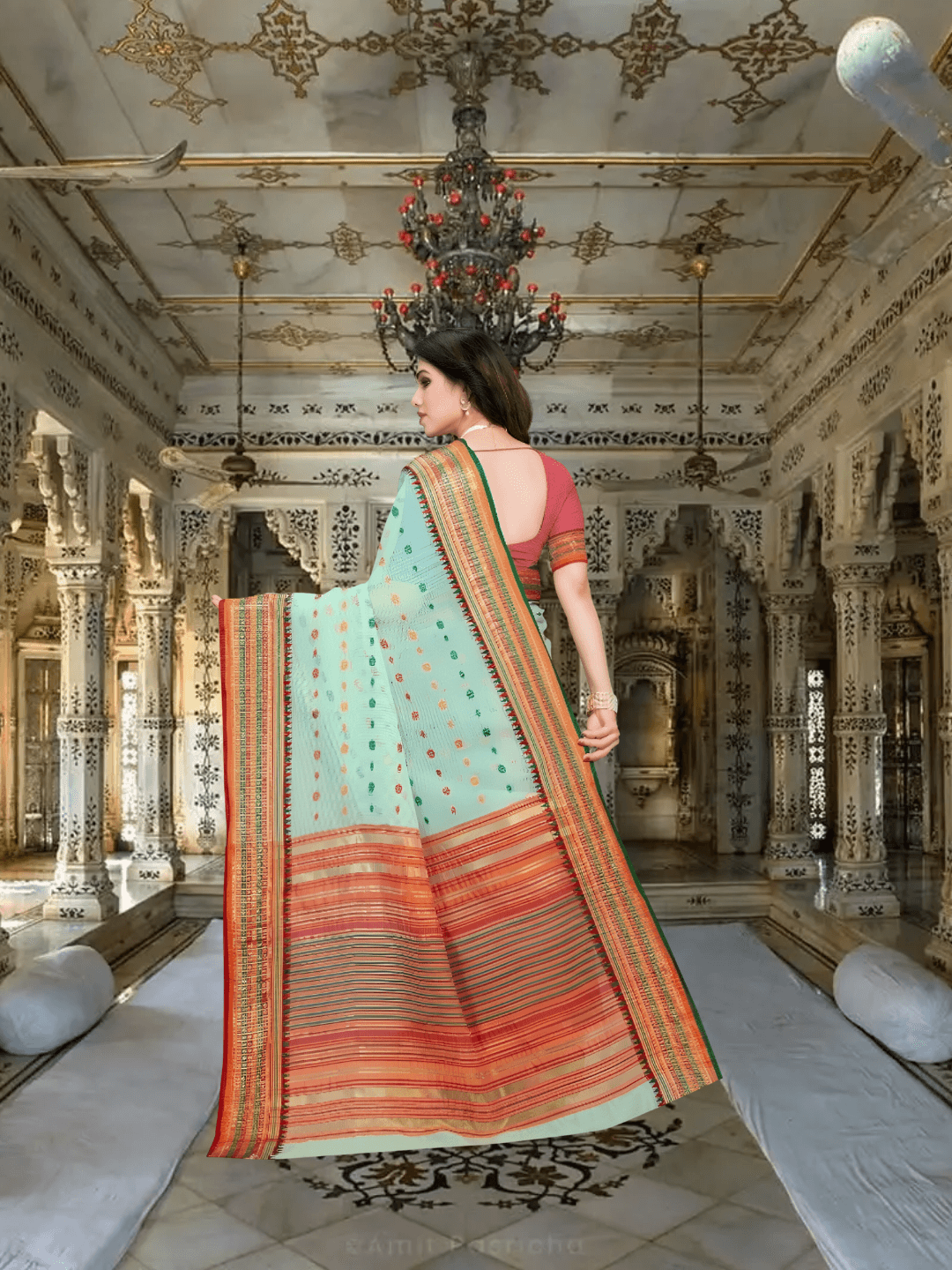 Graceful pallu in pink-gold weave flowing softly in a palace room setting