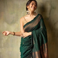 Model in a graceful green silk saree posing in palace interiors