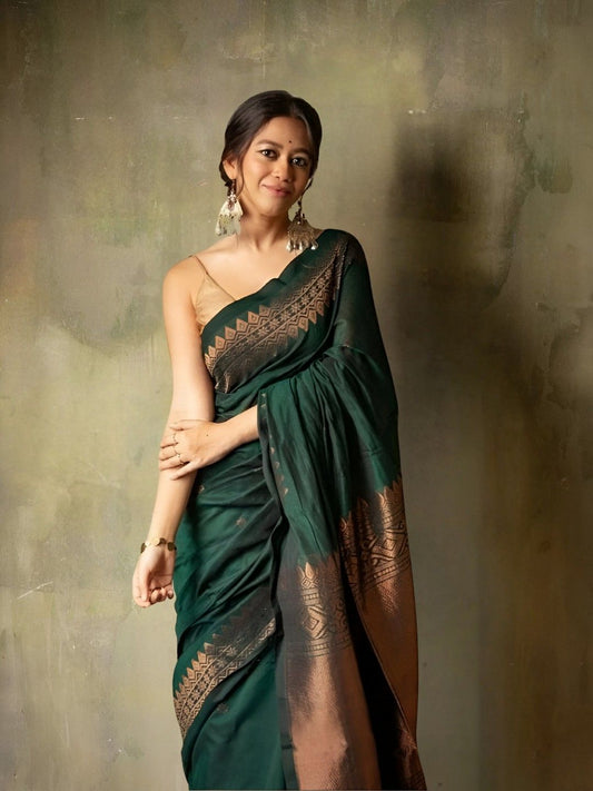 Model in a graceful green silk saree posing in palace interiors