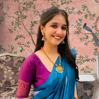 Front view of Rama green silk saree in royal setting