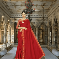 Model in sindoor red silk blend saree with golden patterns inside palace
