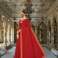 Graceful pose in red-gold saree with palace elements in background