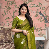 Front angle of green printed cotton crape saree glowing in regal palace light