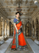 Model draped in orange Kota Doria saree under vintage arches, borders reflecting temple tones