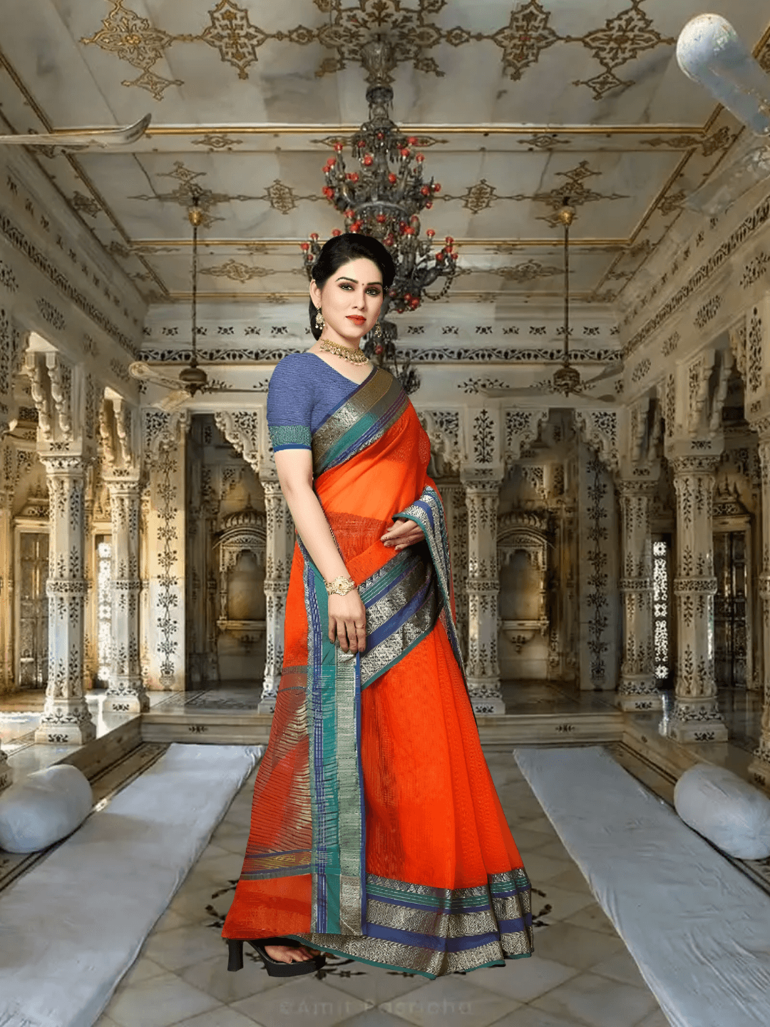 Model draped in orange Kota Doria saree under vintage arches, borders reflecting temple tones