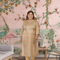 Front view: Light orange kurti glowing under golden arches