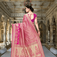 Close-up of abstract gold threadwork resembling ancient scripts against rich pink silk