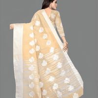 Beige saree styled with gold jewelry for evening weddings
