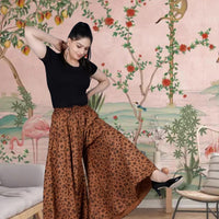 Front view of brown jaguar print palazzo pants in palace setting