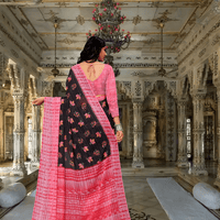 Model flipping pallu to reveal lace-like black patterns