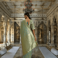 Detailed pallu view of pista green saree with rich gold weave