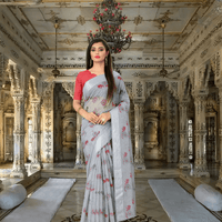 Model standing in royal room draped in simple grey cotton saree with calm expression
