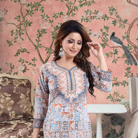 Front view of multicolor kurti against crumbling mural, sleeves catching confetti