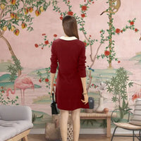 Back view showcasing fitted maroon silhouette and collar contrast