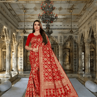Model standing in palace archway, red saree glowing under golden chandeliers