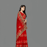 Red net saree flat lay on grey slate, gold motifs placed like a jeweler’s final draft