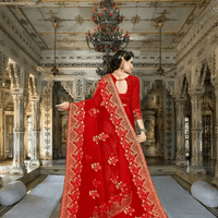 Backlit shot with saree flaring like a scarlet halo, gold thread glowing like embers