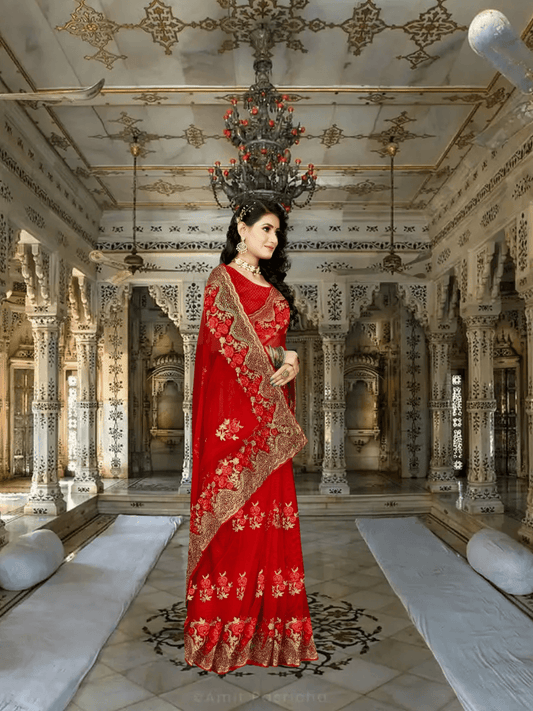 Close-up of sheer red net over hennaed hands, gold embroidery framing like antique lace