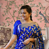 Front view of divine blue Litchi silk printed saree in temple-like palace setting
