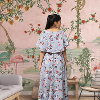 Back view of CELESTINA grey floral crepe gown in royal backdrop